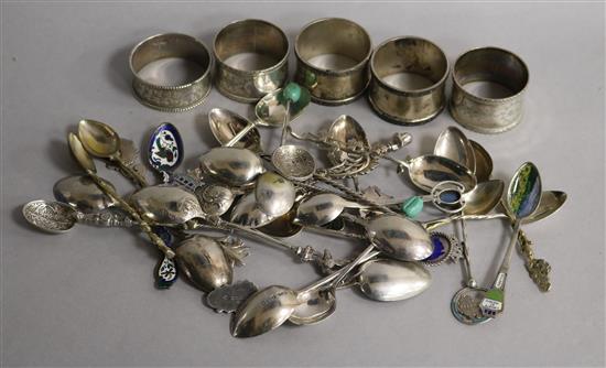 A collection of silver and silver plated souvenir and other spoons and five silver napkin rings, etc.